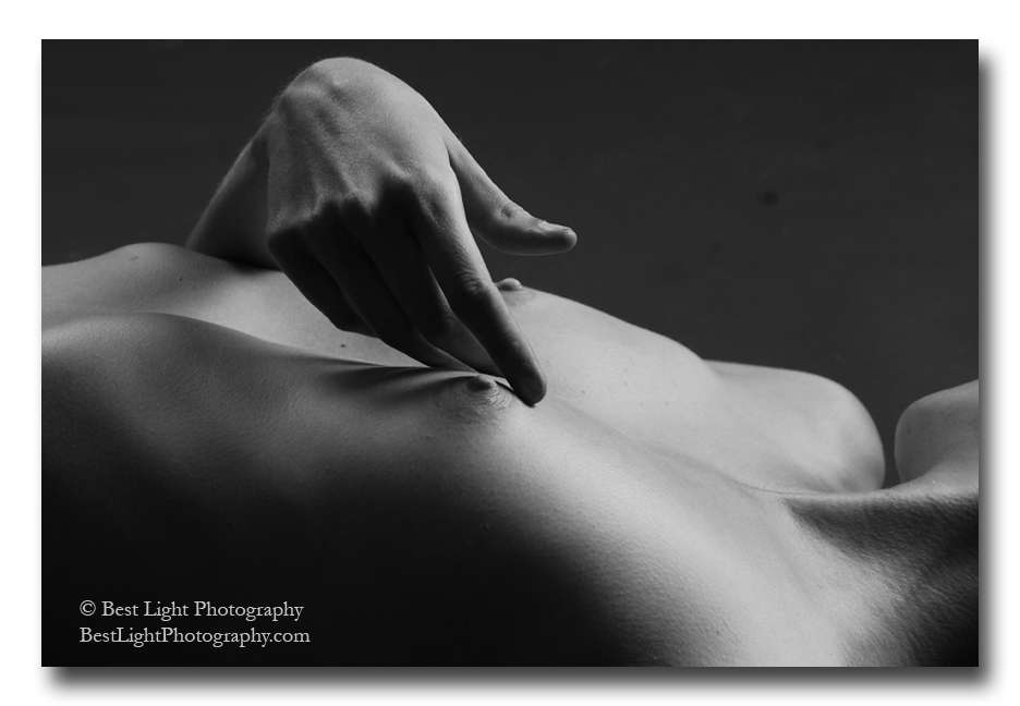 black and white photograph nude female lying breasts with hand