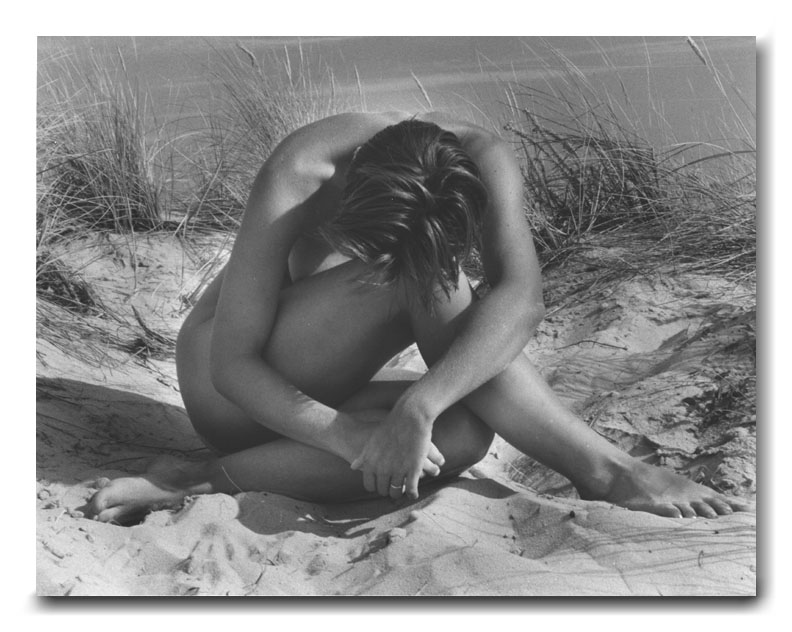 black and white photograph nude girl seated beach