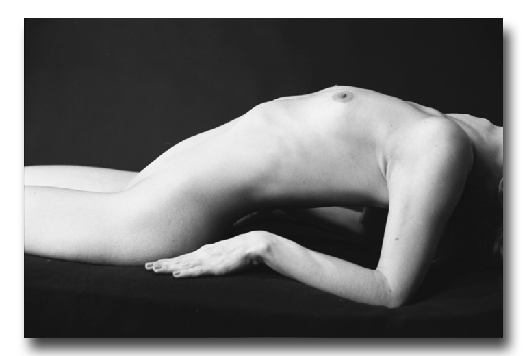 black and white photograph nude girl lying arched